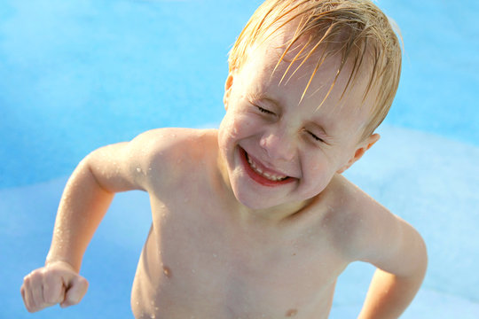 Happy Little Boy in Swimming Pool