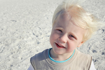 Portrait of Happy Young Child at Windy Beach