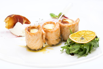 baked salmon rolls on a table in a restaurant