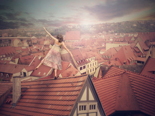 Young girl on top of the roof. Photomanipulation. Cncept digital