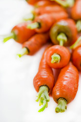 Fresh baby carrots on a white background
