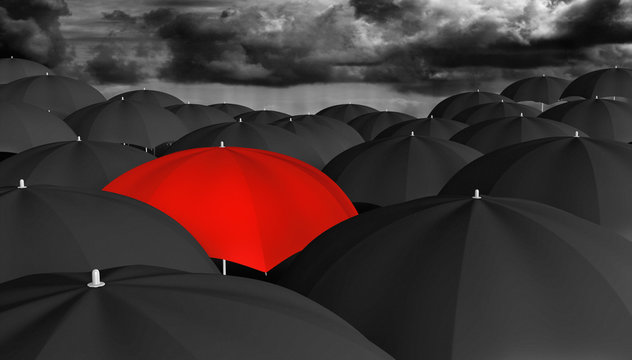 Individuality and different concept of a red umbrella in a crowd