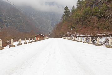 snow road to the house in mountain