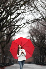 Umbrella woman walking in Central Park in winter