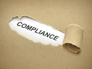 the word compliance behind torn paper