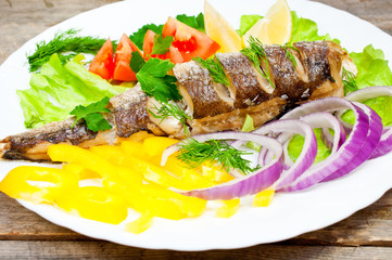 fish hake baked with vegetables on a plate