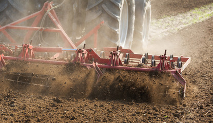 Fototapeta na wymiar Close up shot of seedbed cultivator machine at work