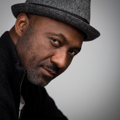 Black Man With Stubble Wearing A Hat