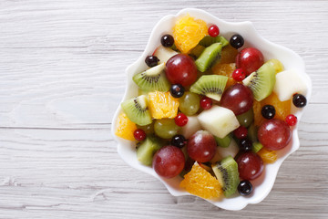 Fruit salad of oranges, grapes. pears, kiwi horizontal top view