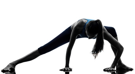 woman exercising yoga stretching legs warm up silhouette