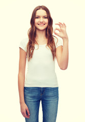 woman in blank white t-shirt showing ok gesture