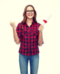 smiling female student in eyeglasses with diploma