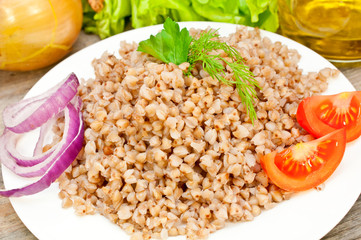 buckwheat groats in a bowl on a wooden table