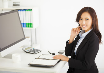happy young business woman working in the office