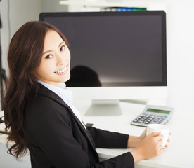 Fototapeta na wymiar happy young business woman working in the office
