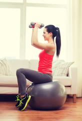 smiling girl exercising with fitness ball
