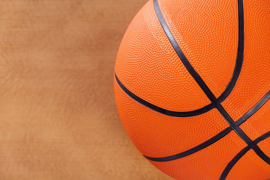Basketball over wooden floor