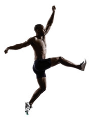 Fototapeta na wymiar young african muscular build man jumping running silhouette