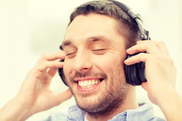 smiling young man in headphones at home