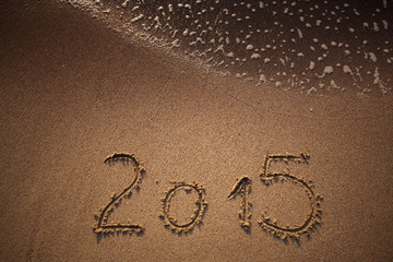 New year 2015 written in sand