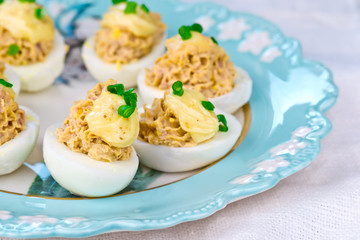 delicious stuffed eggs on blue plate.