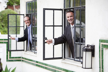two businessmen looking out of a window