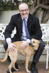 Obraz na płótnie Canvas man in suit with a dog