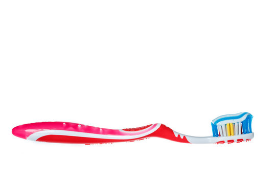 toothbrush with blue two color toothpaste on light