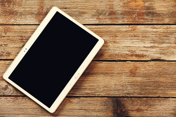 Tablet computer on a wooden background