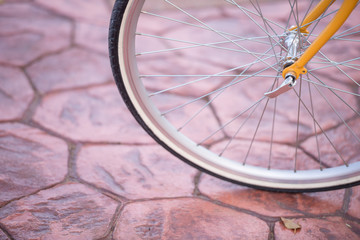 Single spoke wheel of bicycle on textured background