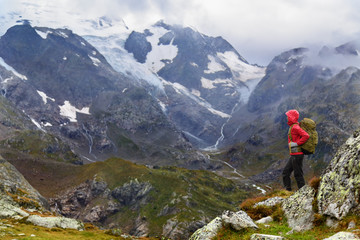 Hiking - hiker woman on trek with backpack in rain