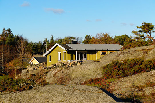 Green cottage hidden between the rocks