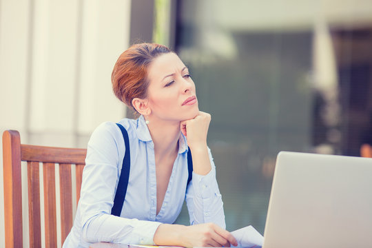 worried business woman sitting in front of laptop computer