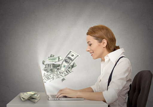 woman using her laptop computer making money grey background 
