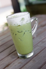 Glass of iced green tea latte.