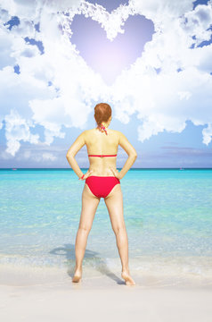 Young asian woman wearing red bikini standing facing the sea