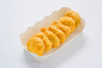 Chicken nuggets on a plate with sauce and vegetables on the plat