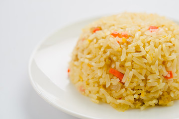 Rice and vegetables on a plate with a white background.