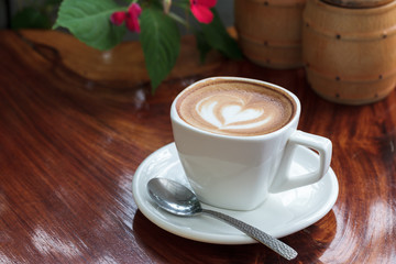 Cup of latte coffee on wooden