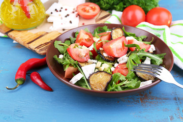 Eggplant salad with tomatoes, arugula and feta cheese,