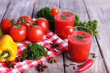 Tomato juice in glasses and fresh vegetables