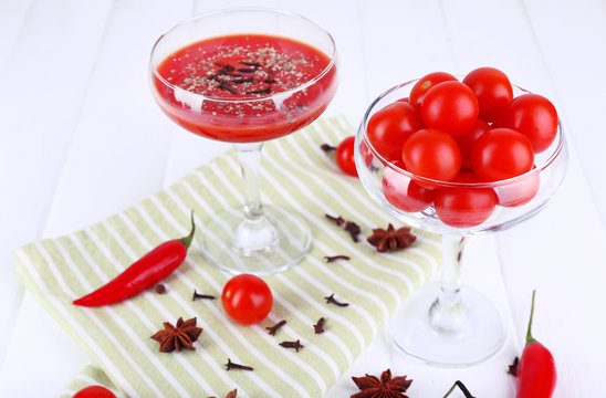 Tomato juice in goblet and fresh vegetables