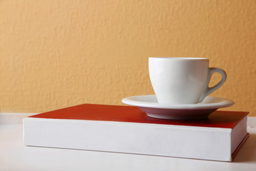 Civil Law book with cup on tabletop and light wall background