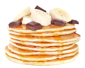 Stack of delicious pancakes with chocolate, honey and slices of
