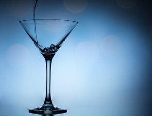 cocktail pouring in martini glasses