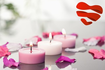 Obraz na płótnie Canvas Composite image of lighted candles and petals