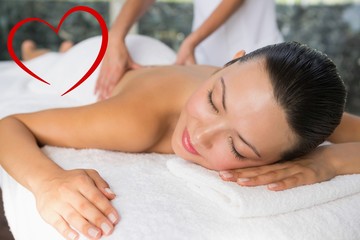 Fototapeta na wymiar Composite image of content brunette enjoying a back massage