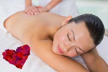 Obraz na płótnie Canvas Composite image of content brunette enjoying a back massage