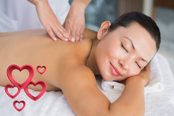 Obraz na płótnie Canvas Composite image of content brunette getting a back massage