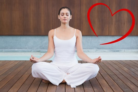 Composite image of peaceful woman in white sitting in lotus pose